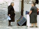 two ladys in Skyros town talking in the mainstreet